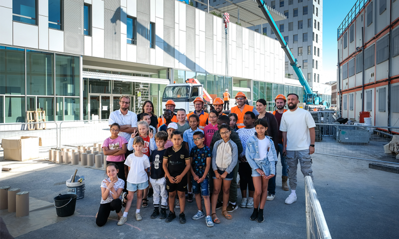 Groupe scolaire Ivry 3E : 25 classes maternelles et élémentaires, un gymnase d'une capacité de 700 personnes et une résidence étudiante de 279 logements : c’est l’ensemble du groupe scolaire que viennent de livrer nos équipes à Ivry-sur-Seine. Les façades atypiques sont composées de bardage en cassettes métalliques avec un jeu de quinconce des menuiseries extérieures et des charpentes bois sur près de 1000 m². Quant au gymnase, il est réalisé à partir d’une charpente métallique et d’une poutre en béton coulée en place de près de 7m de hauteur et 50cm de large pour une portée de 35m et pesant 350t. Un programme d’immersion avait permis aux futurs écoliers et à l’équipe pédagogique de découvrir l’avancée du chantier. La rentrée s’y est déroulée comme prévu le 1er septembre et l’inauguration officielle est envisagée le 24 septembre. (Maîtrise d’ouvrage : SADEV 94 / Maîtrise d’œuvre : Emmanuelle Colboc & Associés)